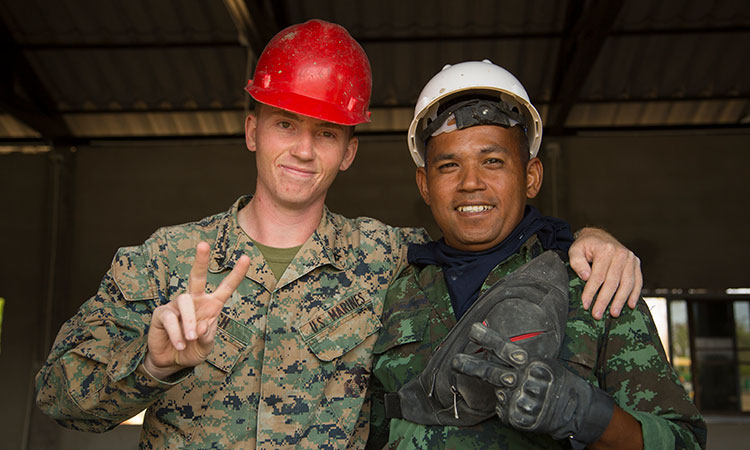 U.S. Marine Lance Cpl. Jonathon Couch, an electrician with Marine Wing Support Squadron 171, 1st Marine Aircraft Wing, with Royal Thai Army Sergeant Major First Class Tralrak Tongsomrld during an engineering civic action project (U.S. Marine Corps photo by Staff Sgt. Jordan E. Gilbert)
