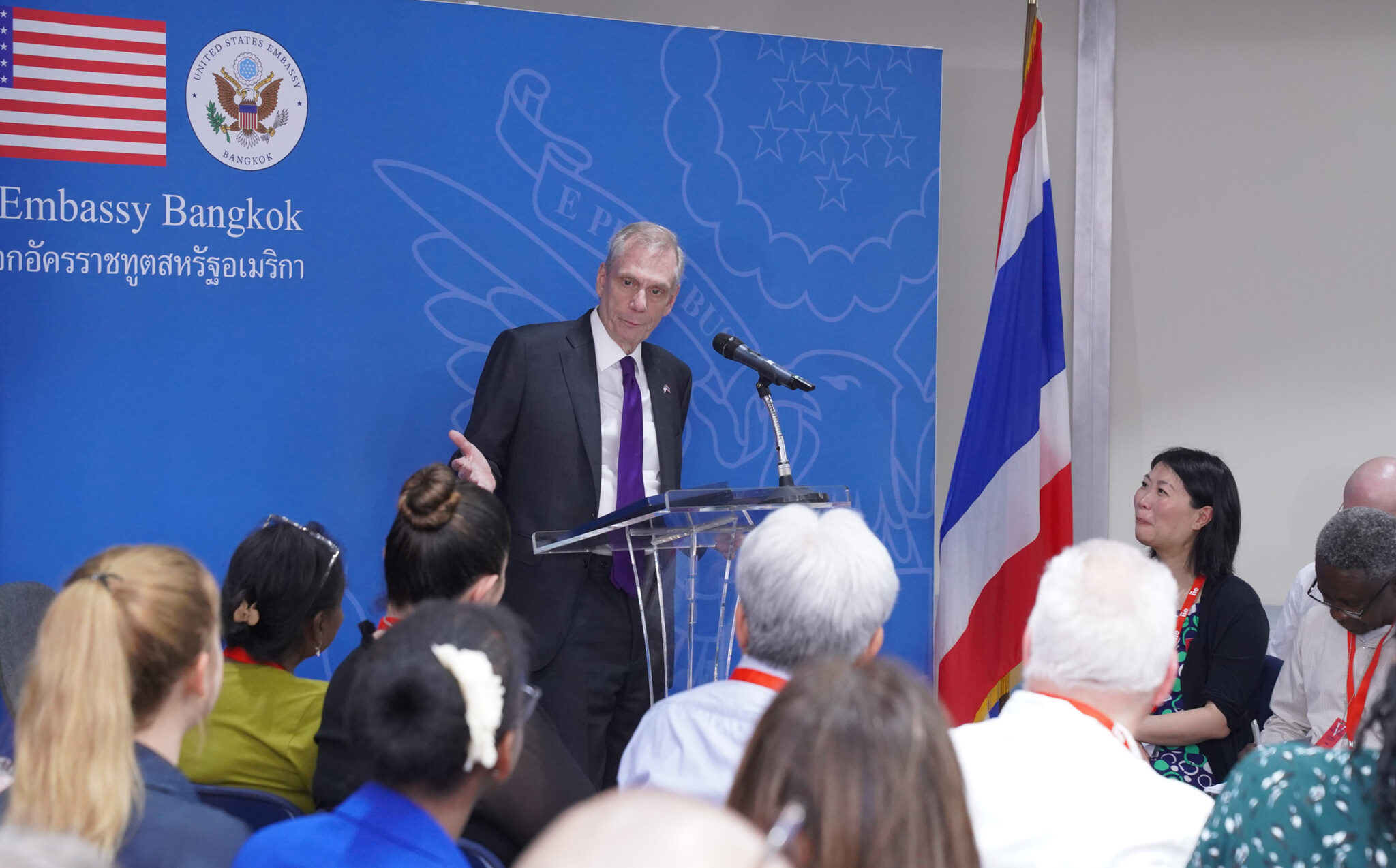 Ambassador opening up remarks behind podium