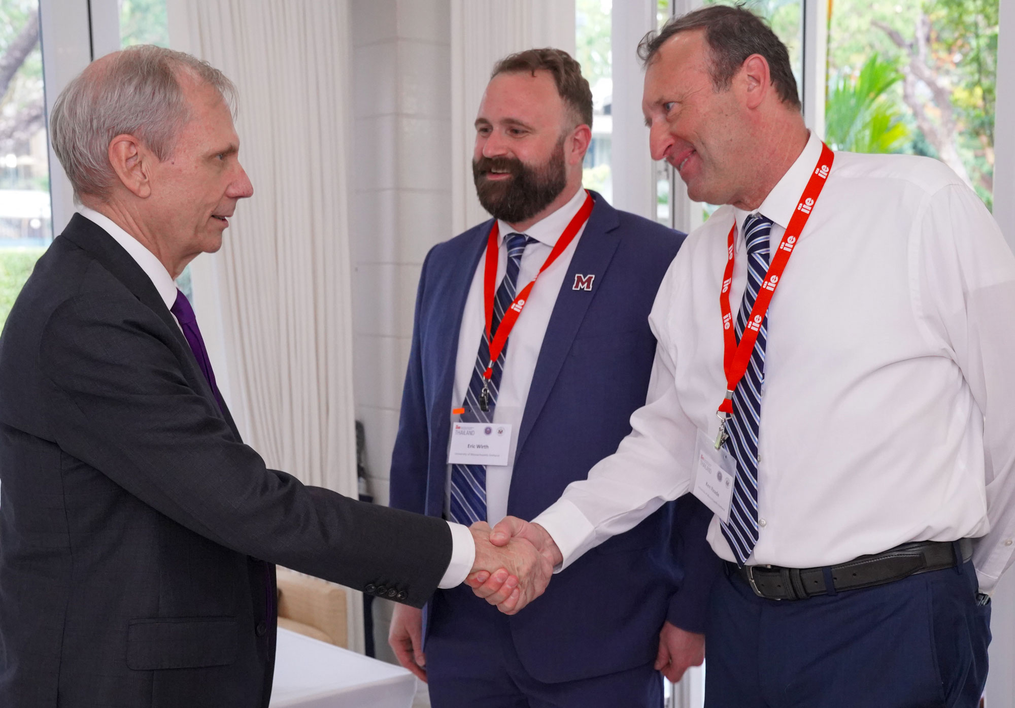 Ambassador Godec shakes hands with participants